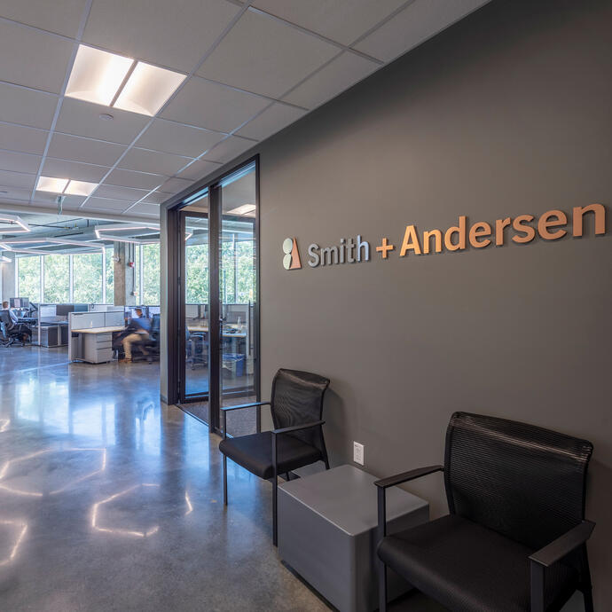 Interior view of Smith + Andersen office with signage in foreground