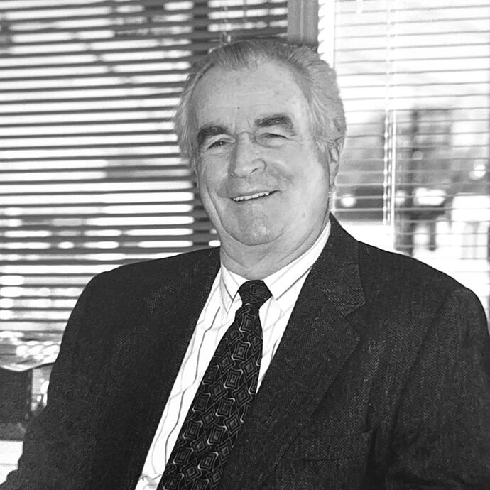 Black and white photo of an elderly man in a suit.