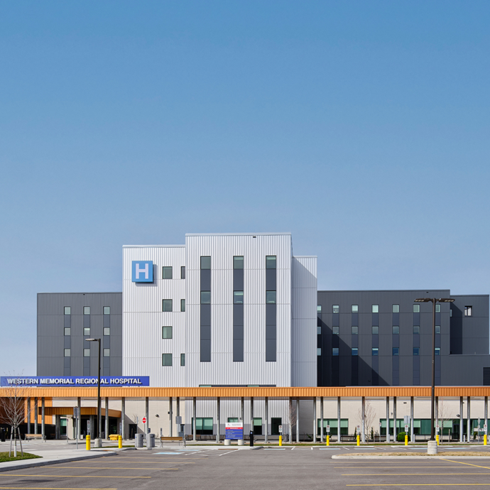 Photo of the exterior of Western Memorial Regional Hospital from the front entrance on a sunny day.