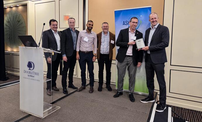 Six men accept the ASHRAE award on stage.